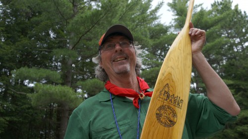 Kevin Callan - The Happy Camper - hiding the Killarney Outfitters paddle