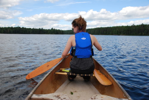 Paddling in a canoe to hide the paddled
