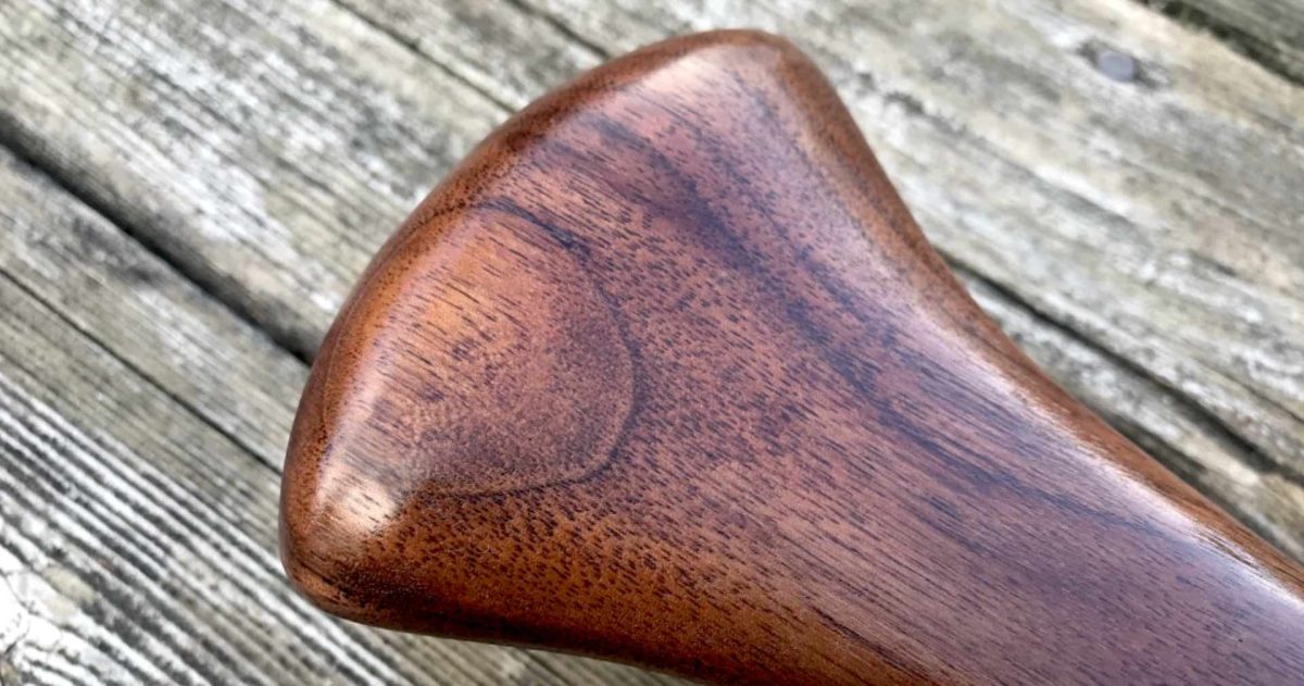 Special Edition Limited Issue Walnut Badger Canoe Paddle grip on rustic wood background