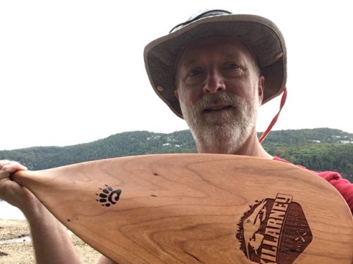 Bill Graham holding a Badger LaBonga paddle he won in the Paddle in the Park Contest